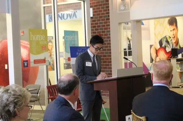 a student presents to a group of adults
