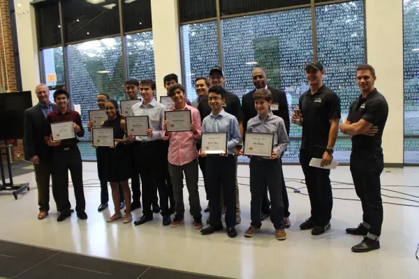 group of students standing together after their presentation