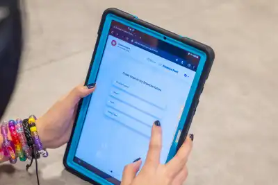 A student holds a tablet