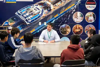 A volunteer talks to a group of students