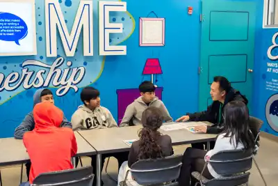 A volunteer speaks with a group of students