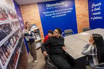 A volunteer talks with a group of students