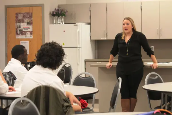 woman speaking in front of a group of students